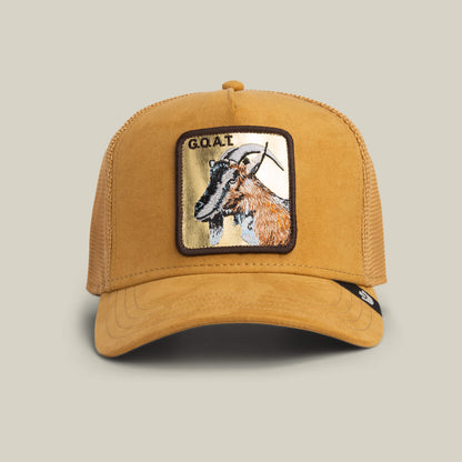 The Goorin Bros. Golden Goat trucker hat in AMBER features a suede front, mesh back, and an embroidered goat patch with bold G.O.A.T. text for standout style.