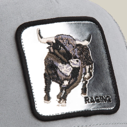 A close-up of the Goorin Bros. Silver Bull patch, featuring an embroidered silver bull and "RACING" in black caps—ideal for adding flair to your favorite gray trucker hat.