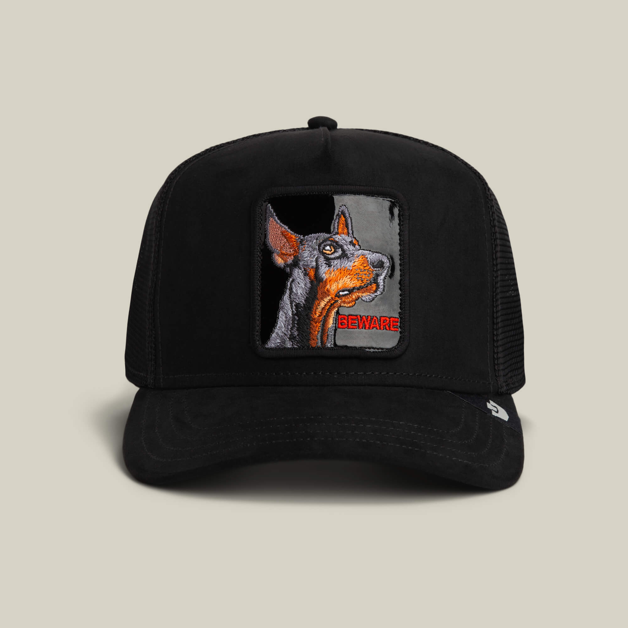 The Goorin Bros. Black Out Doberman trucker hat in VOID features a Doberman patch with "BEWARE" embroidered in red on the front.