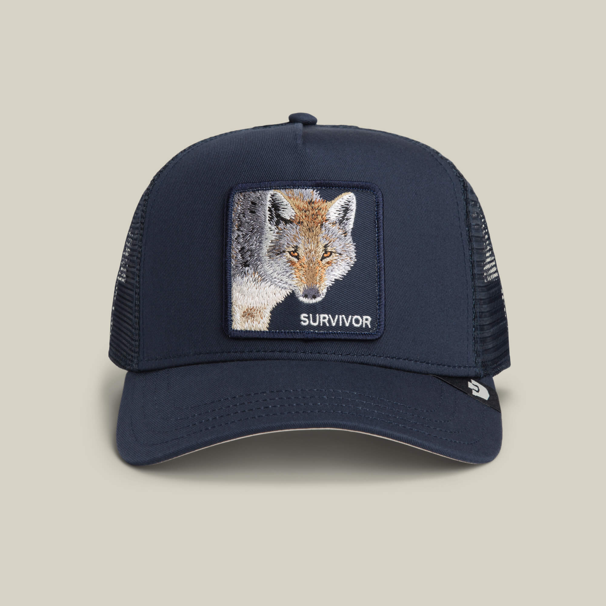 The Survivor Trucker by Goorin Bros. in EDGE color is a mesh-back trucker hat with an embroidered survivor patch featuring a fox and "SURVIVOR" on the front.