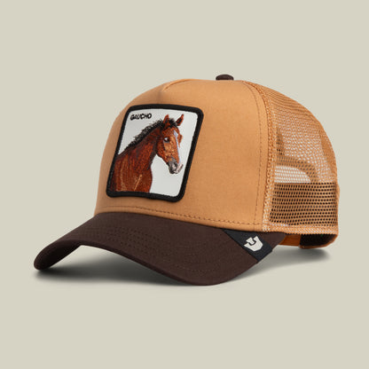 Tan and brown Gaucho Trucker hat in an earthy colorway with a patch featuring a horse and the word GAUCHO.