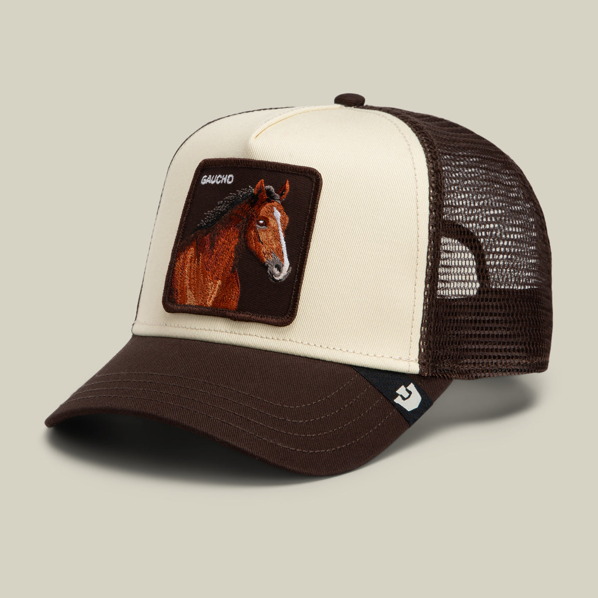 Brown and cream Gaucho Trucker hat featuring an embroidered horse patch with the text GAUCHO above the image.