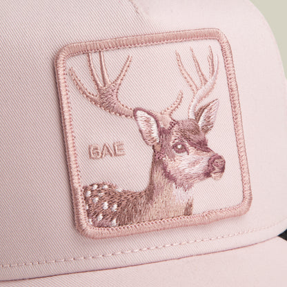 Close-up of the Mirage Bae pink baseball cap by Goorin Bros., featuring a deer patch with antlers and "BAE" stitched beside it—a playful yet classic accessory.