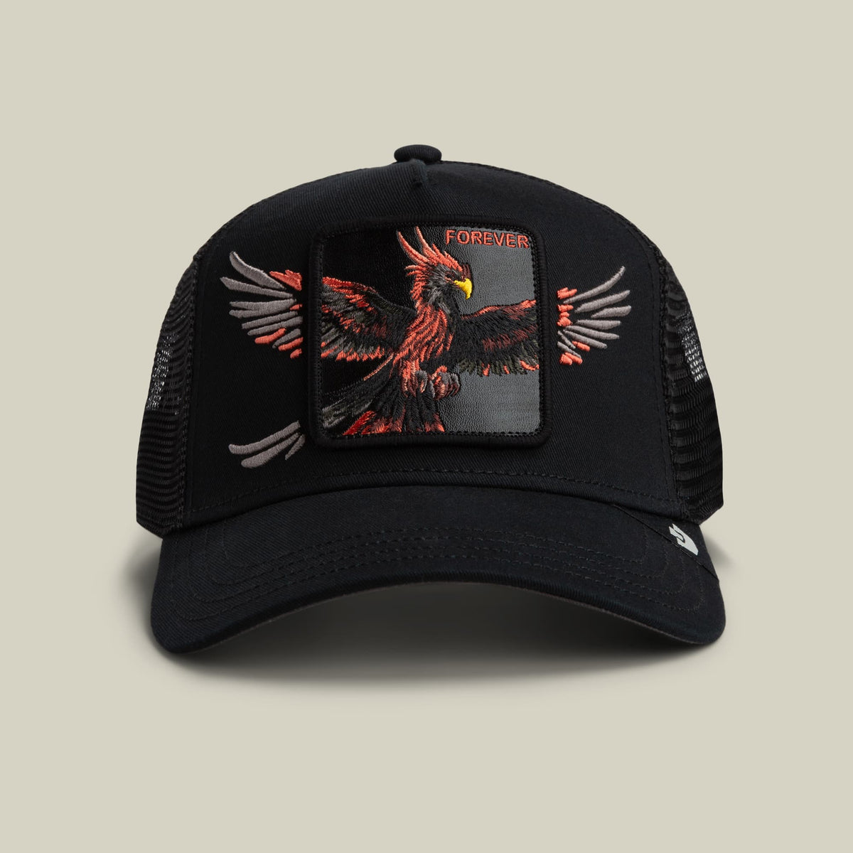 The Wings Forever trucker hat by Goorin Bros features a black mesh back and solid front panel with a large embroidered red and orange phoenix design and gray wing details, displayed on a neutral background.