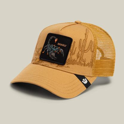 The Goorin Bros. Badlands Scorpion hat is a tan trucker cap with a mesh back, featuring an embroidered cactus design and a "Deadly" scorpion patch, plus a small black and white logo tag on the bill.