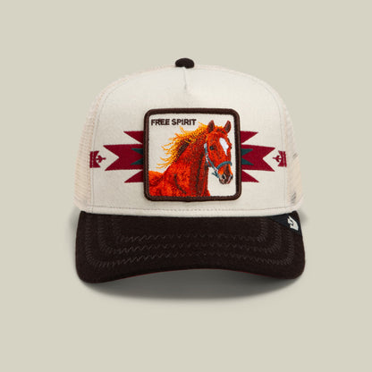 The Goorin Bros. Canyon Free Spirit trucker hat features a white mesh back, black bill, and cream front panel with burgundy lightning bolt details and a red embroidered horse patch reading Free Spirit.