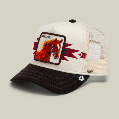 The Goorin Bros. Canyon Free Spirit trucker hat features a cream mesh back, black bill, and burgundy accents with an embroidered red horse patch on the front panel.