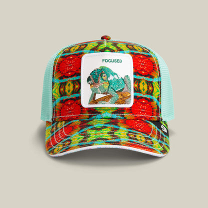 The Goorin Bros. Magic Eye cap features a multicolor chameleon patch with “FOCUSED” on the front and light blue mesh panels for a subtle mirage effect, bringing optical illusions and bold style to your look.