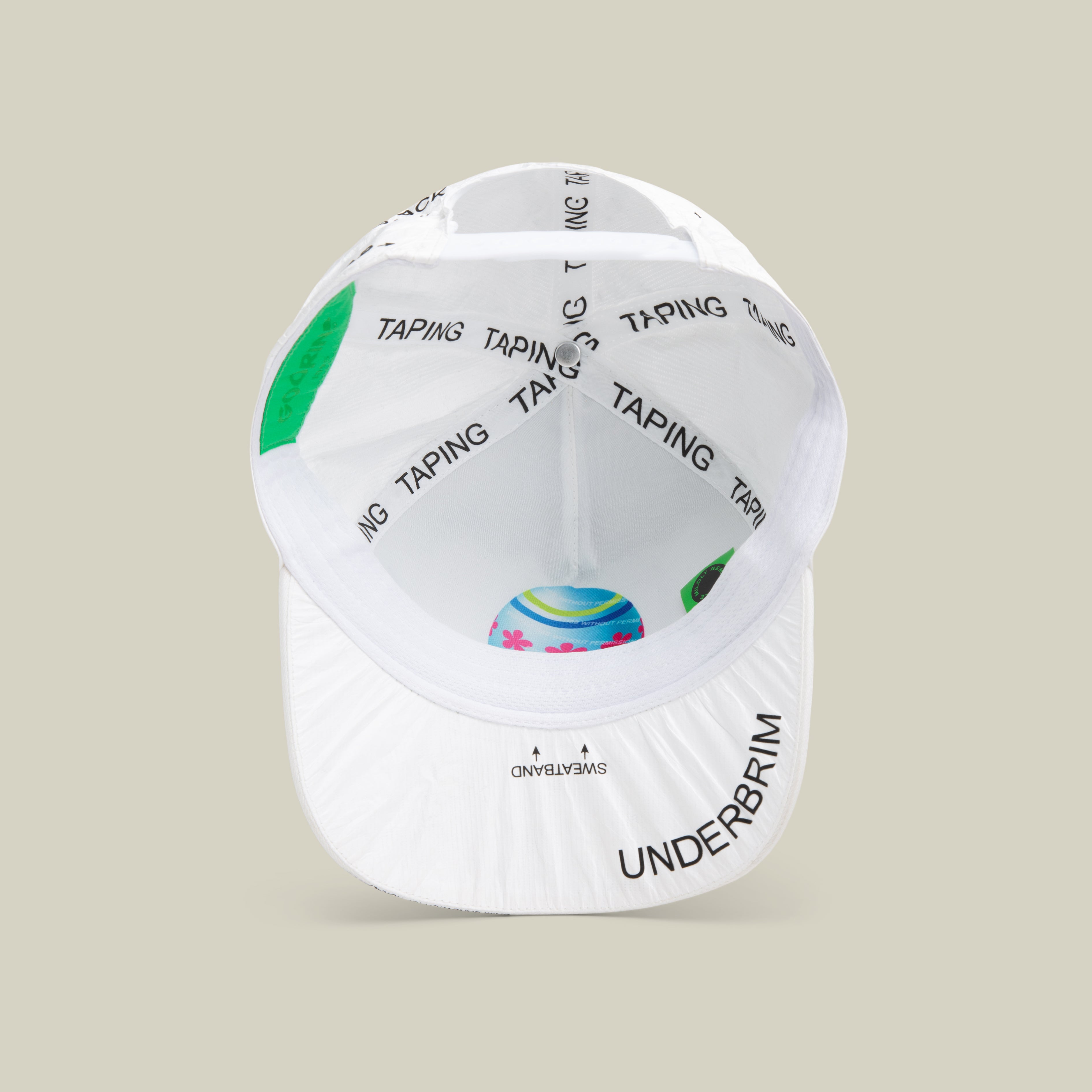 A white limited edition Goorin Bros. K.I.S.S. baseball cap viewed from underneath, featuring black TAPING text along the interior seams and UNDERBRIM text printed at the front edge of the brim.