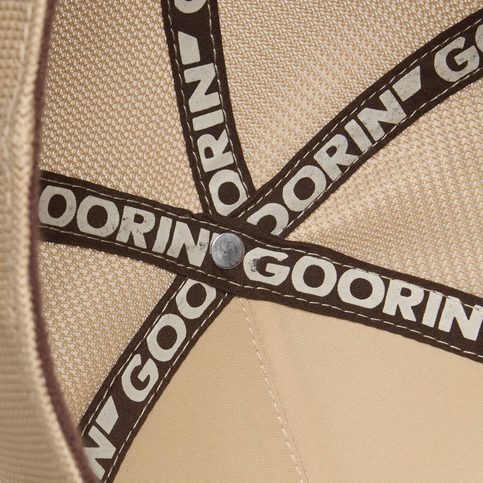 Interior view of the Goorin Bros. "Hey, I Like It! Picasso!" hat in beige, with brown GOORIN bands, a central metal rivet, and subtle digital print embroidery for extra style.