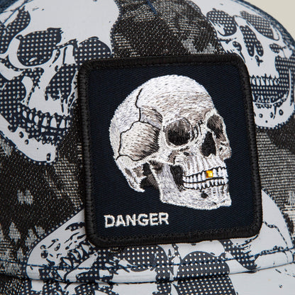 Close-up of the Goorin Bros. Bone Head Danger trucker cap, featuring a black and white mesh-back design with a patch displaying an embroidered skull and the word “DANGER” beneath it.