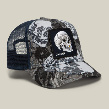 Introducing the Bone Head Danger hat by Goorin Bros. This bold mesh-back trucker hat features striking black and white skull graphics, highlighted by a front patch displaying a skull and the word “DANGER.” Make a statement with this standout accessory.