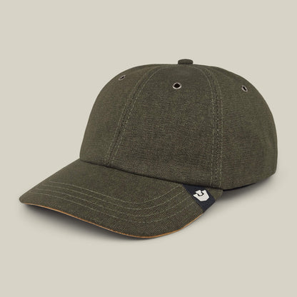 The Goorin Bros. Mineral Road is a dark green mixed-material baseball cap with a curved brim, visible stitching, metal eyelets, and a small logo tag on the side. Made in the USA.