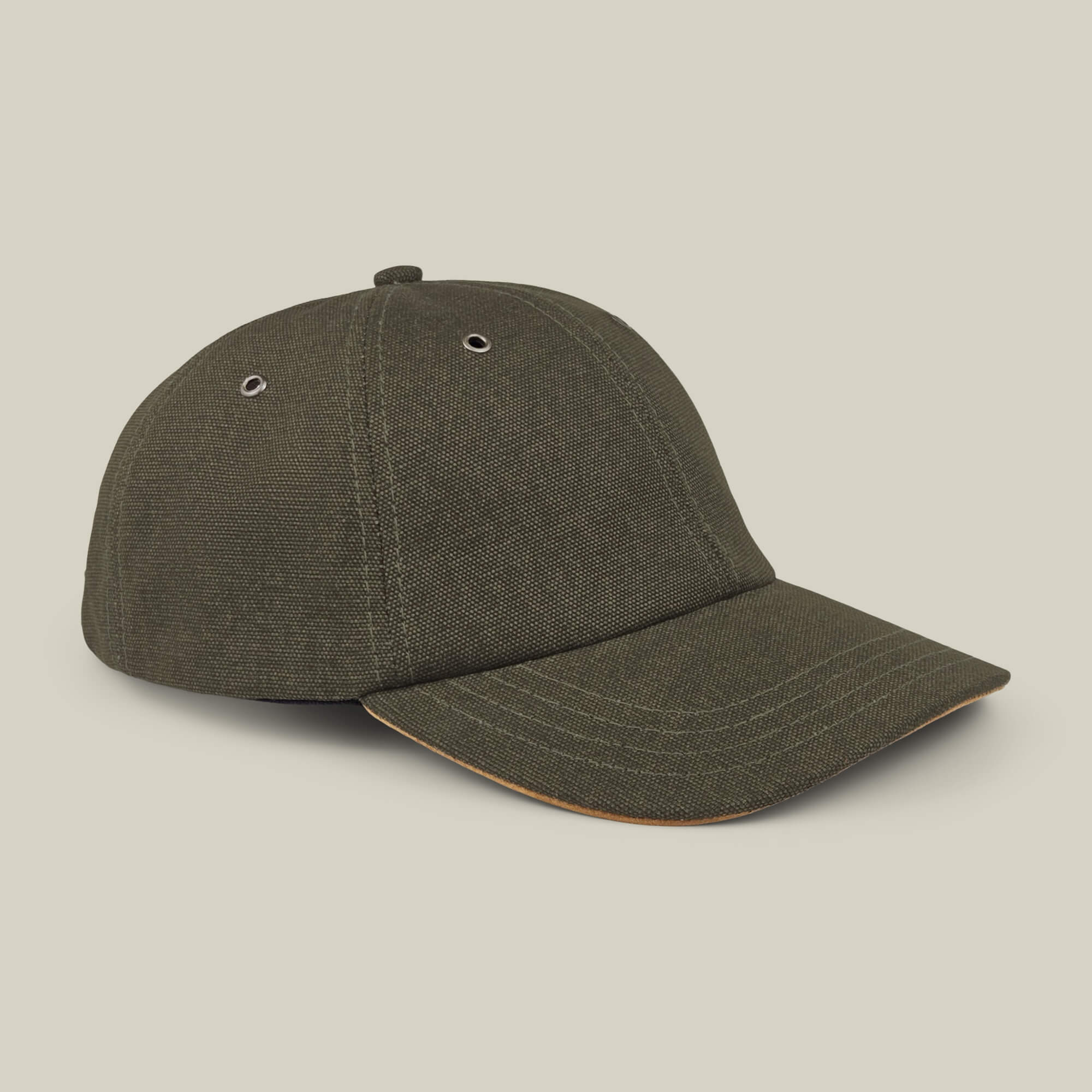 The Goorin Bros. Mineral Road olive green mixed-material baseball cap features a curved brim, metal eyelets on each panel, and is made in the USA, shown against a plain beige background.