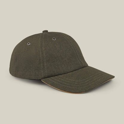 The Goorin Bros. Mineral Road olive green mixed-material baseball cap features a curved brim, metal eyelets on each panel, and is made in the USA, shown against a plain beige background.