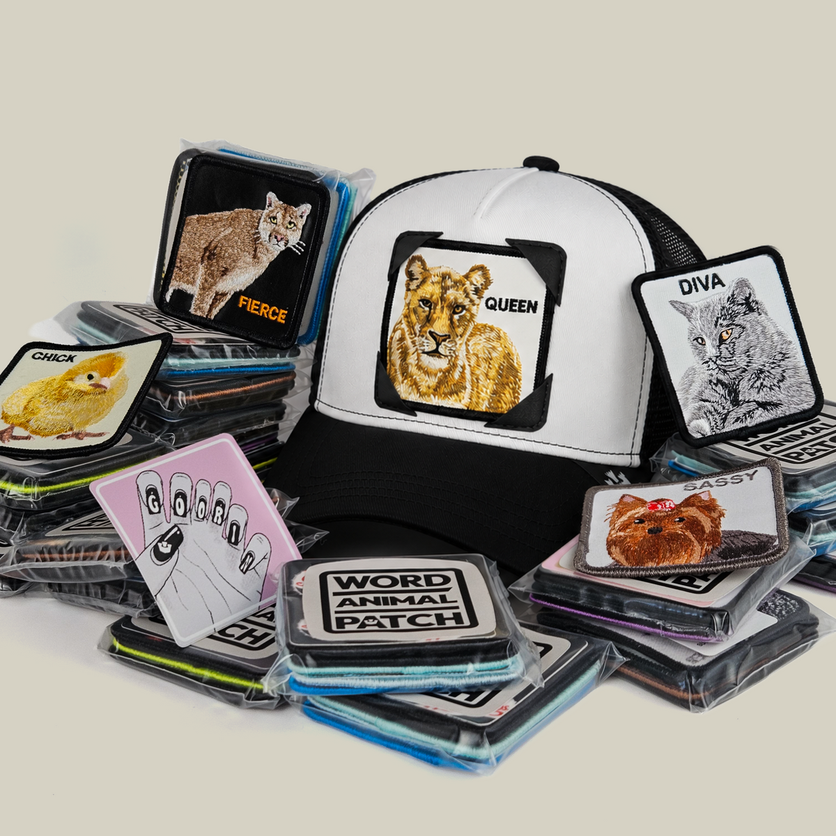 A Gal Pals Patch Pack with GB Patch Corner Trucker - Black and White rests beside a pile of various animal patches and a hand-shaped patch in plastic packaging.