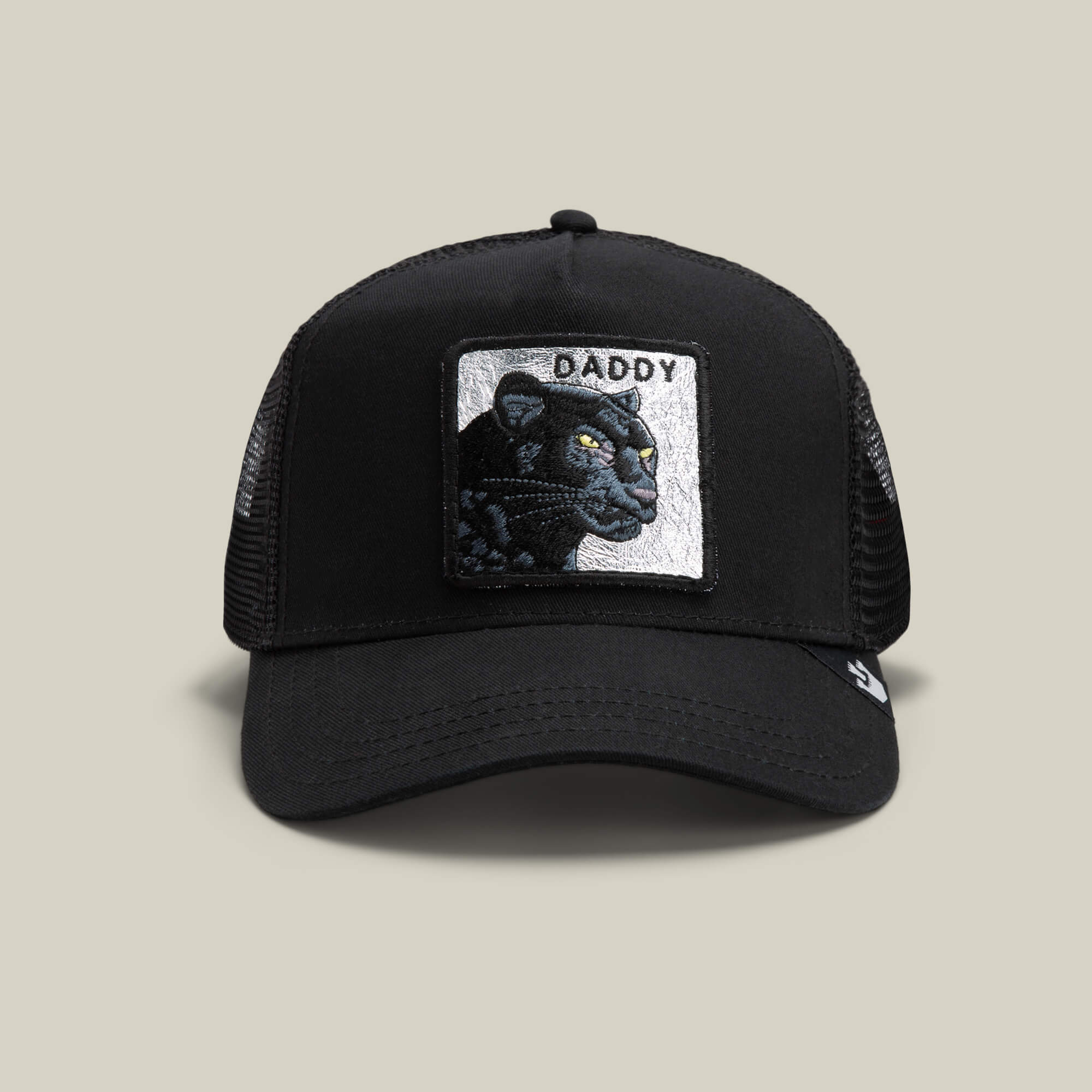The Goorin Bros. Daddy Panther in black is a mesh trucker hat with a front patch featuring an embroidered platinum panther and the word DADDY—an essential accessory for standout style.