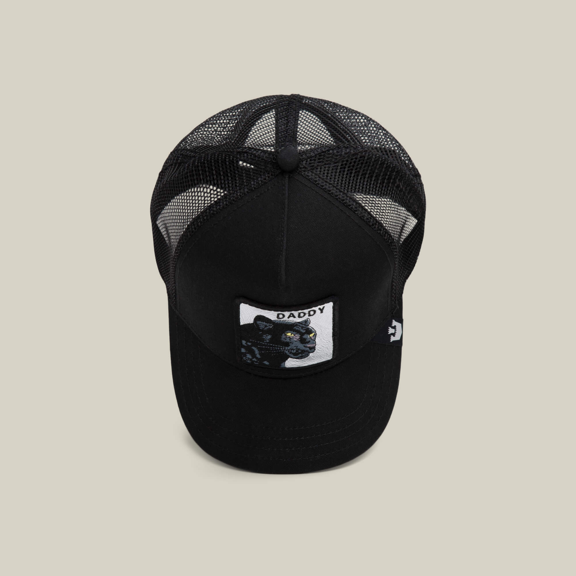 The Goorin Bros. Daddy Panther is a black mesh trucker hat with a front patch showing a platinum panther and the word "DADDY," displayed on a plain, light background.