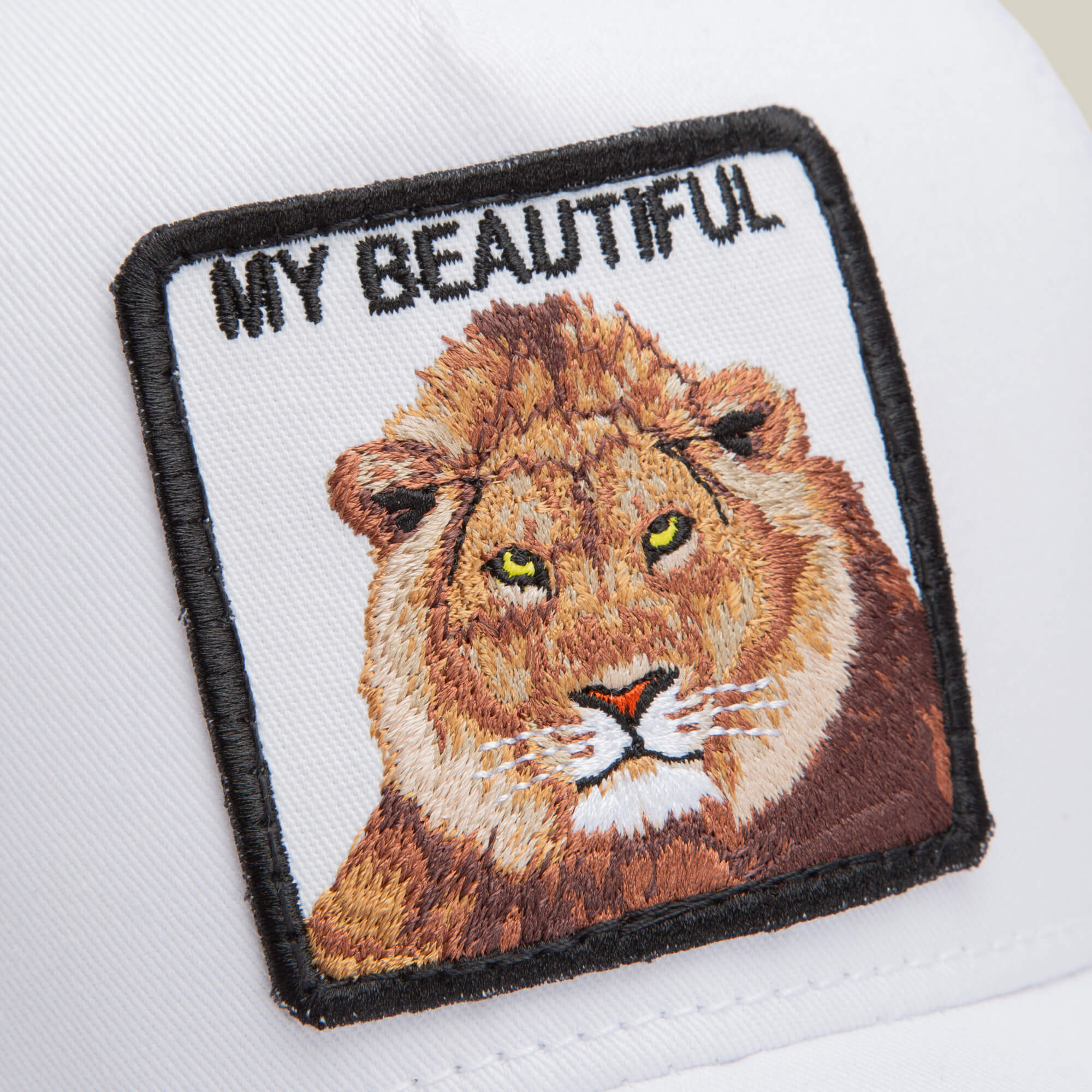 The Goorin Bros. Dave Scott My Beautiful Lion is a white cap with a square embroidered lion patch and the text "MY BEAUTIFUL" above, part of the Dave hat collection.