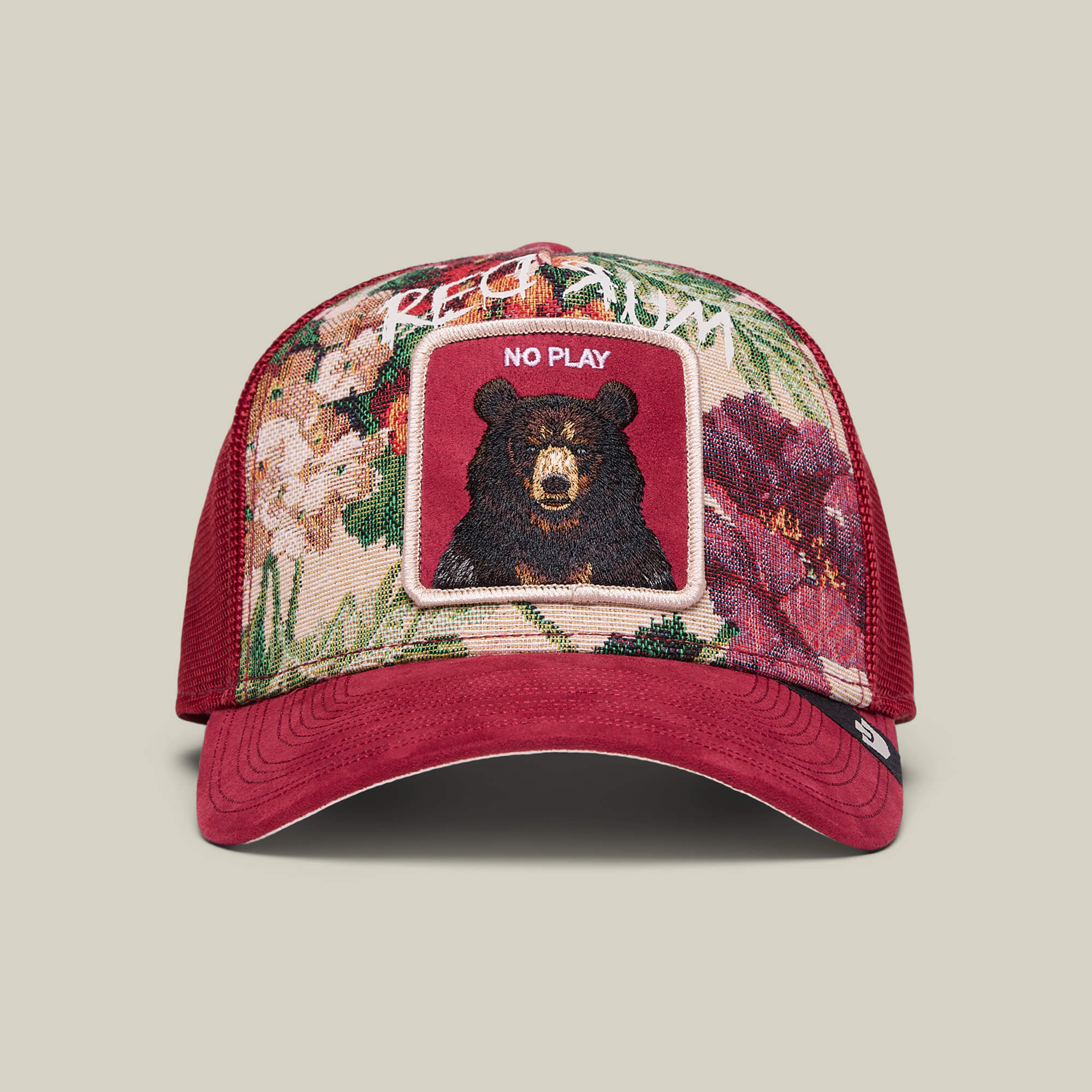 The Dull Boi trucker hat by Goorin Bros. in Crush features a floral pattern, embroidered bear face, and "All Work and No Play" on the front. Part of Johnny's Fresh Friday Drop.