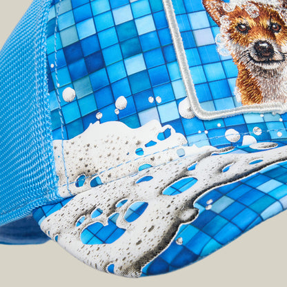 The Squeaky Clean cap by Goorin Bros. features a blue mesh design with a tiled soap suds pattern and partial embroidery of an animal face—possibly a fox—on the front panel, evoking playful bath time vibes.
