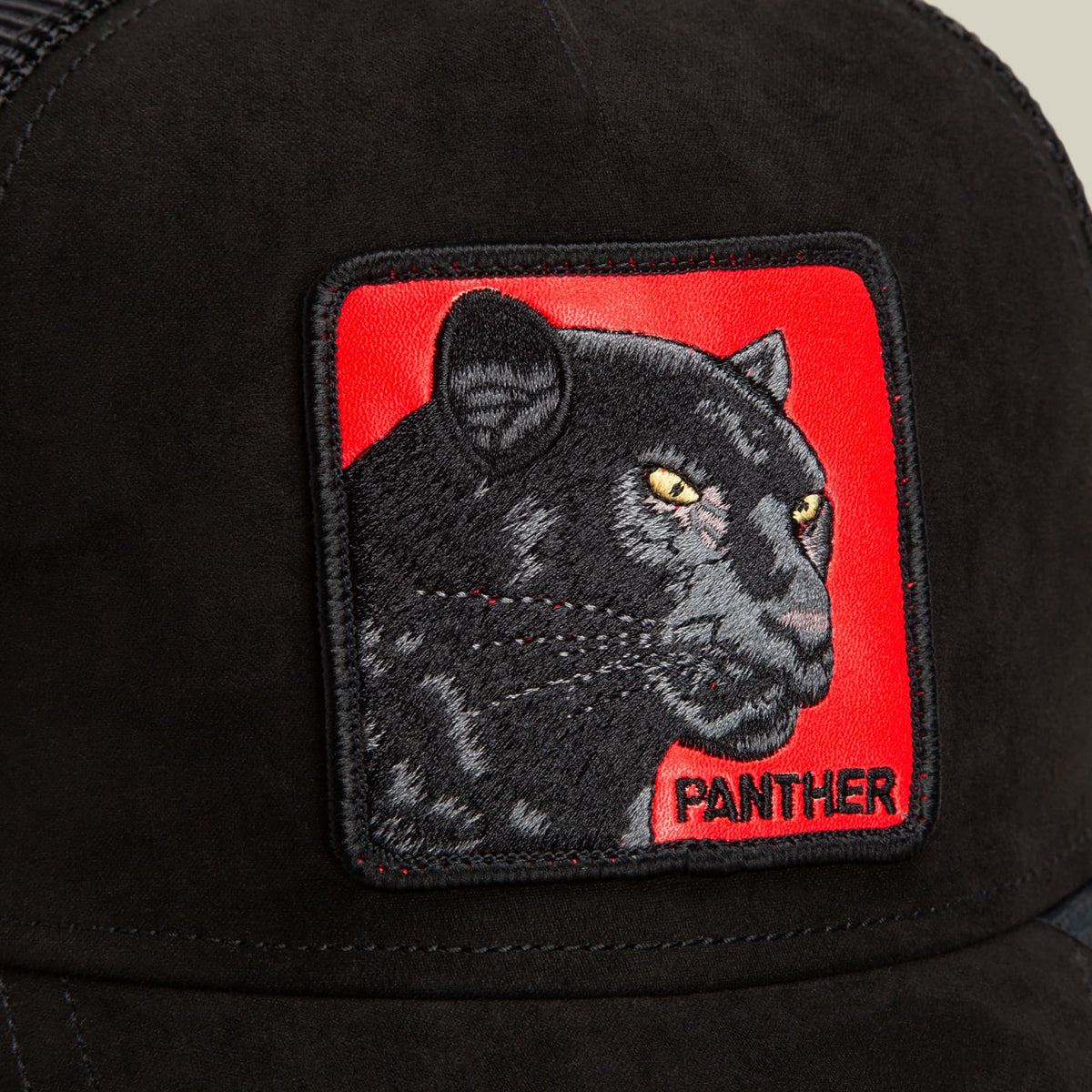 The Goorin Bros. Pantera Nera Rossa is a black trucker hat featuring an embroidered red and black panther patch on the front with gold eyes and the word "PANTHER" below.