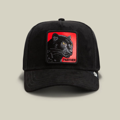 The Goorin Bros. Pantera Nera Rossa is a black mesh trucker hat featuring a bold embroidered patch of a black panther with golden eyes on a red background, displayed on a neutral studio background.