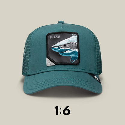 Teal trucker hat by Goorin Bros. with mesh back, showcasing a shark "FLAKE" patch on the front. It's Blind Box 1: U R WUT U EET, part of a mystery animal hat collection (1:6 chance per box).