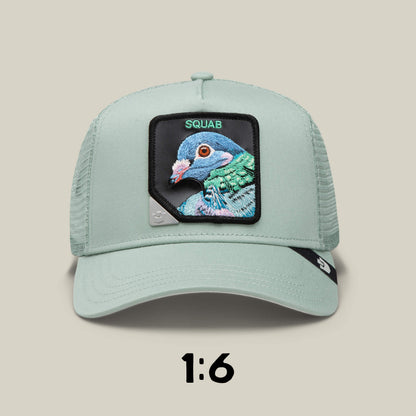 The Blind Box 1: U R WUT U EET by Goorin Bros. features a light green trucker hat with an embroidered pigeon patch labeled SQUAB and a rare 1:6 ratio, making it a unique collectible mystery item.