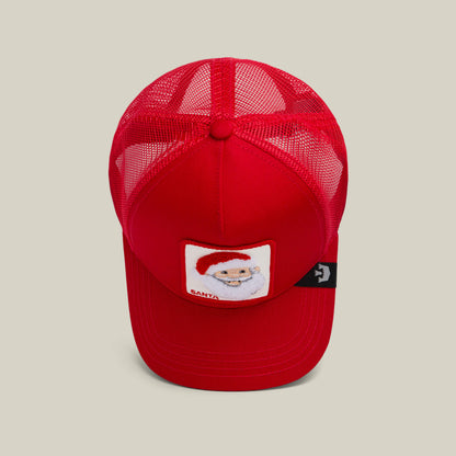 The Goorin Bros. "Mr. Claus" red mesh trucker hat features a Santa Claus patch on the front, making it perfect for the holiday season, shown from above against a neutral background.
