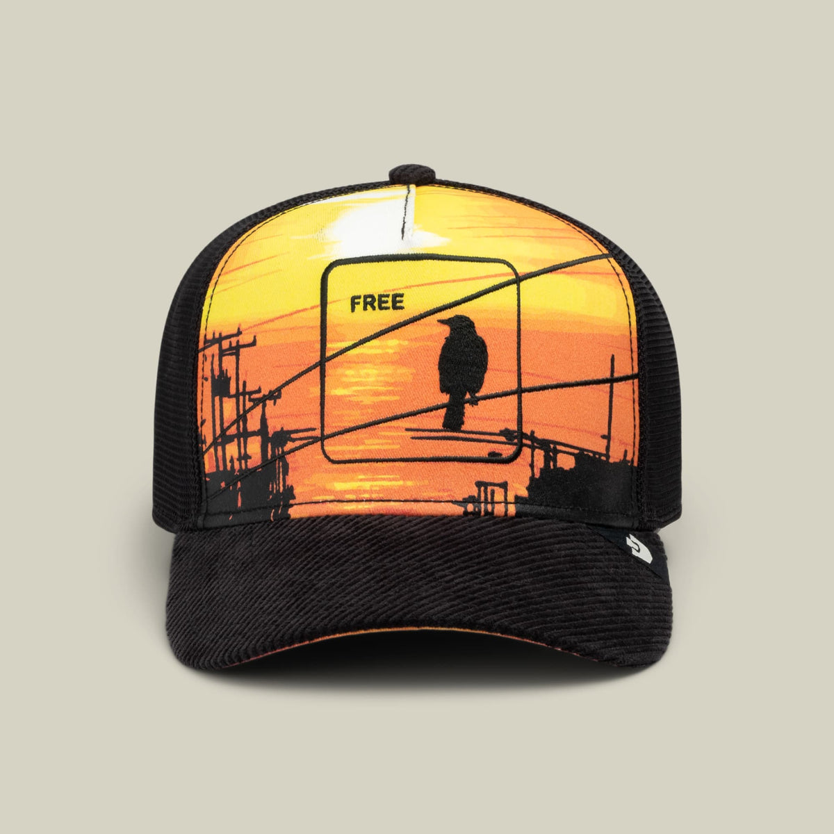 It Was The Hat by Goorin Bros is a black mesh trucker cap with a colorful front panel featuring an illustrated sunset scene with a silhouetted bird perched on power lines and the word FREE.