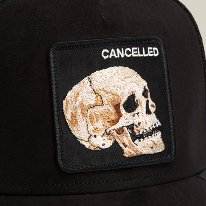 The Bold Suede Skull by Goorin Bros. is a black stitched hat with an embroidered skull patch and the word CANCELLED in white capitals above the skull.