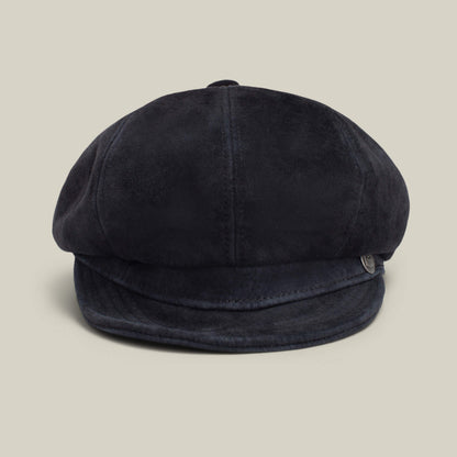 The Ruthy by Goorin Bros. is a black suede cabbie-style flatcap with a short, curved brim, shown against a plain beige background.