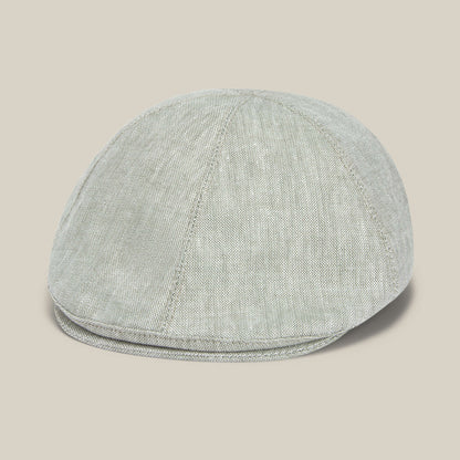 The Benjamin Paul flat cap by Goorin Bros. features light gray textured linen with visible stitching, making it a stylish everyday hat, displayed against a neutral beige background.