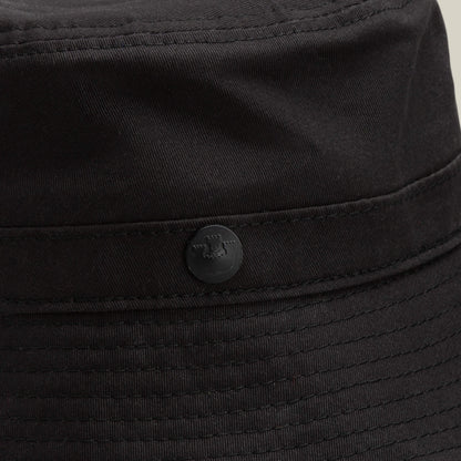Close-up of the Goorin Bros. Odyssey Bucket hat in solid black cotton, featuring visible stitching and a small round button detail on the side.