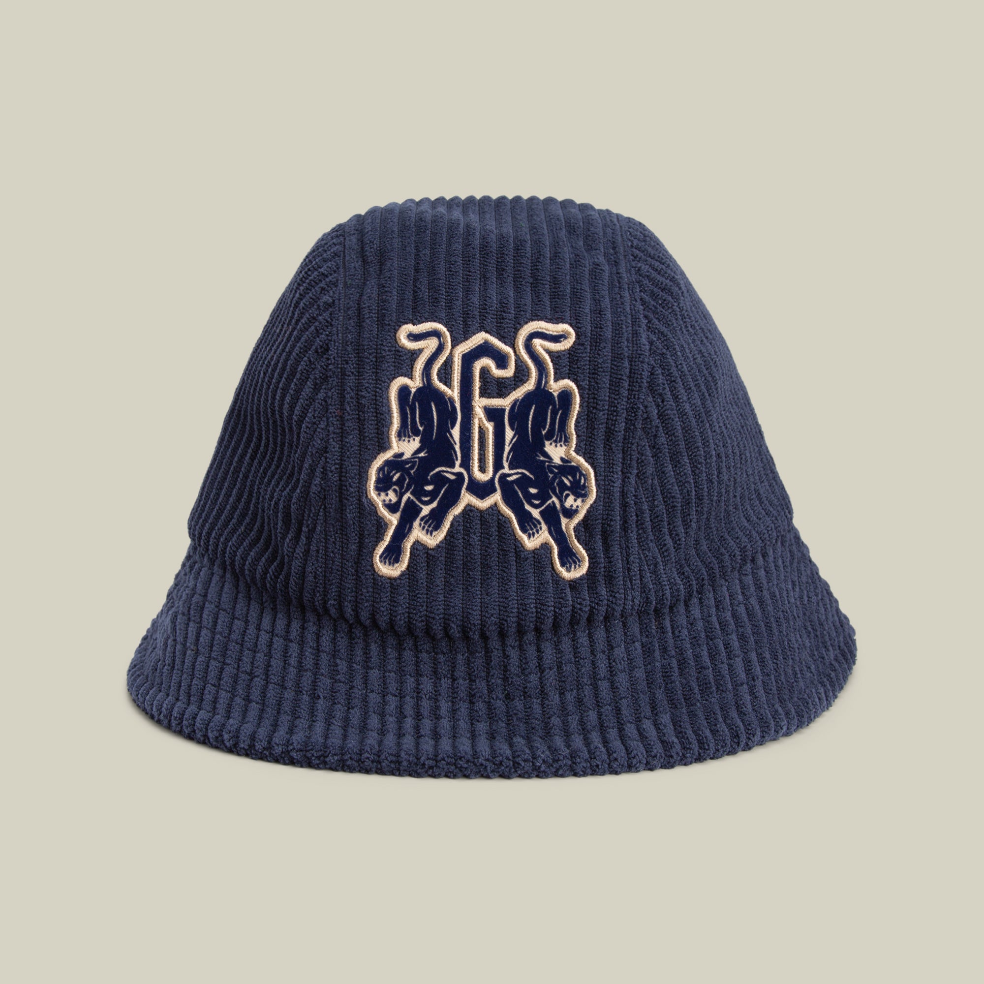 The Yes Coach bucket hat by Goorin Bros. is a navy corduroy style with bold ribs and mirrored twin panther patches embroidered on the front.