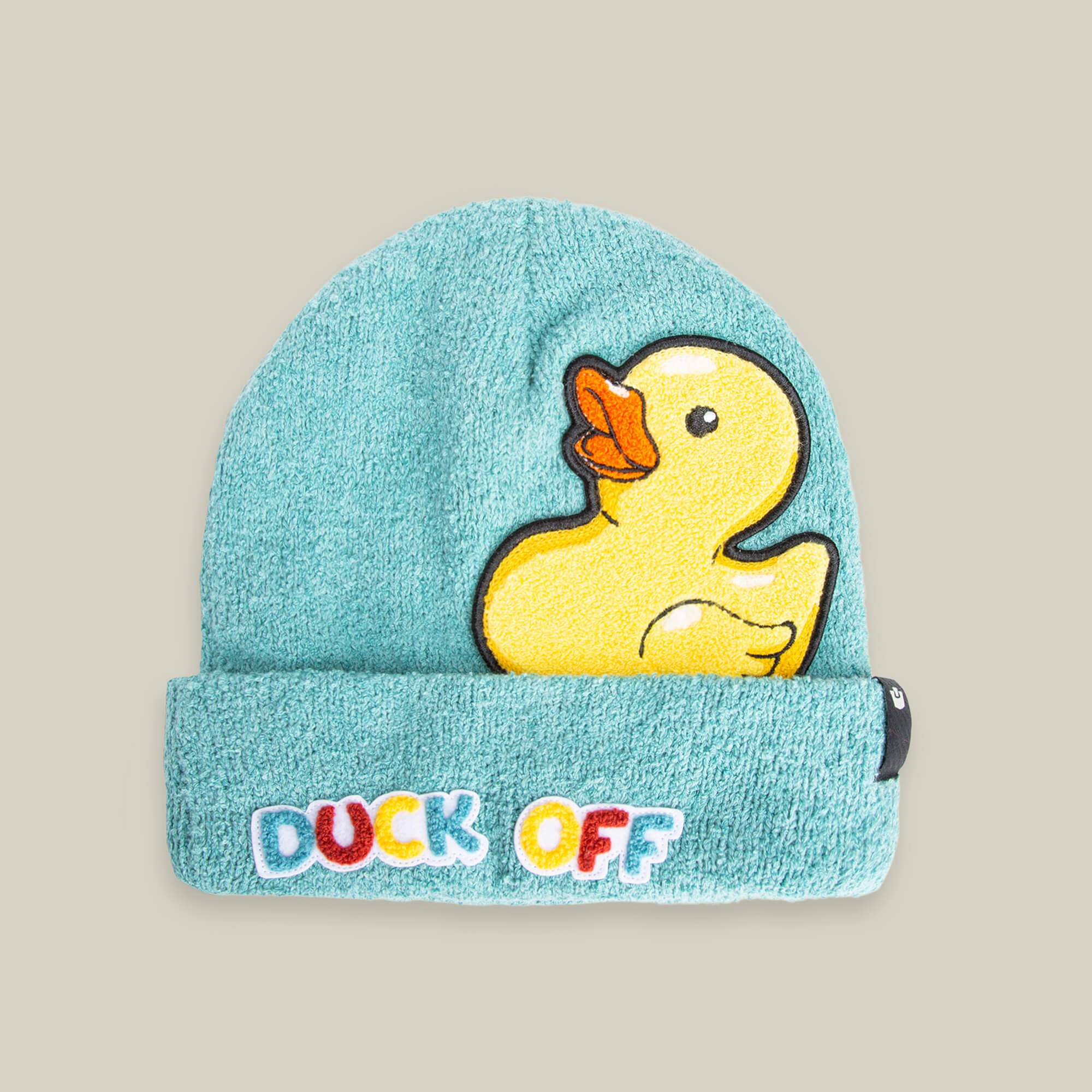 The "Awfully Fond of You" beanie by Goorin Bros. is a light blue soft knit hat featuring a yellow duck patch and the phrase "DUCK OFF" in colorful letters on the front cuff.