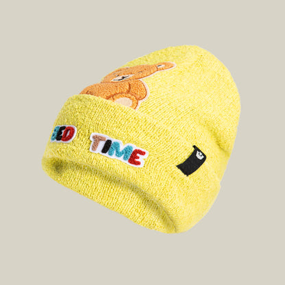 A yellow soft knit “Nap World” beanie by Goorin Bros. featuring an embroidered bear, colorful TIME text, and a black and white patch on the cuff—ideal for fans of playful sleepy bear styles.