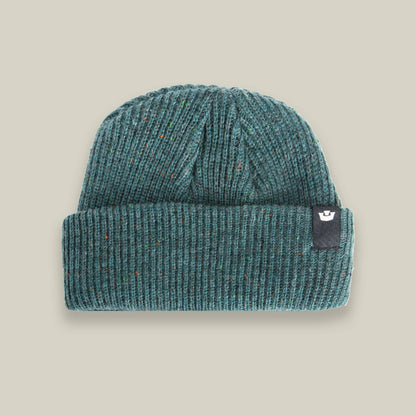 The No Comply beanie by Goorin Bros. is a warm teal knit with a folded brim and a small black logo tag on the right side, shown on a neutral background—ideal comfort for chilly days.