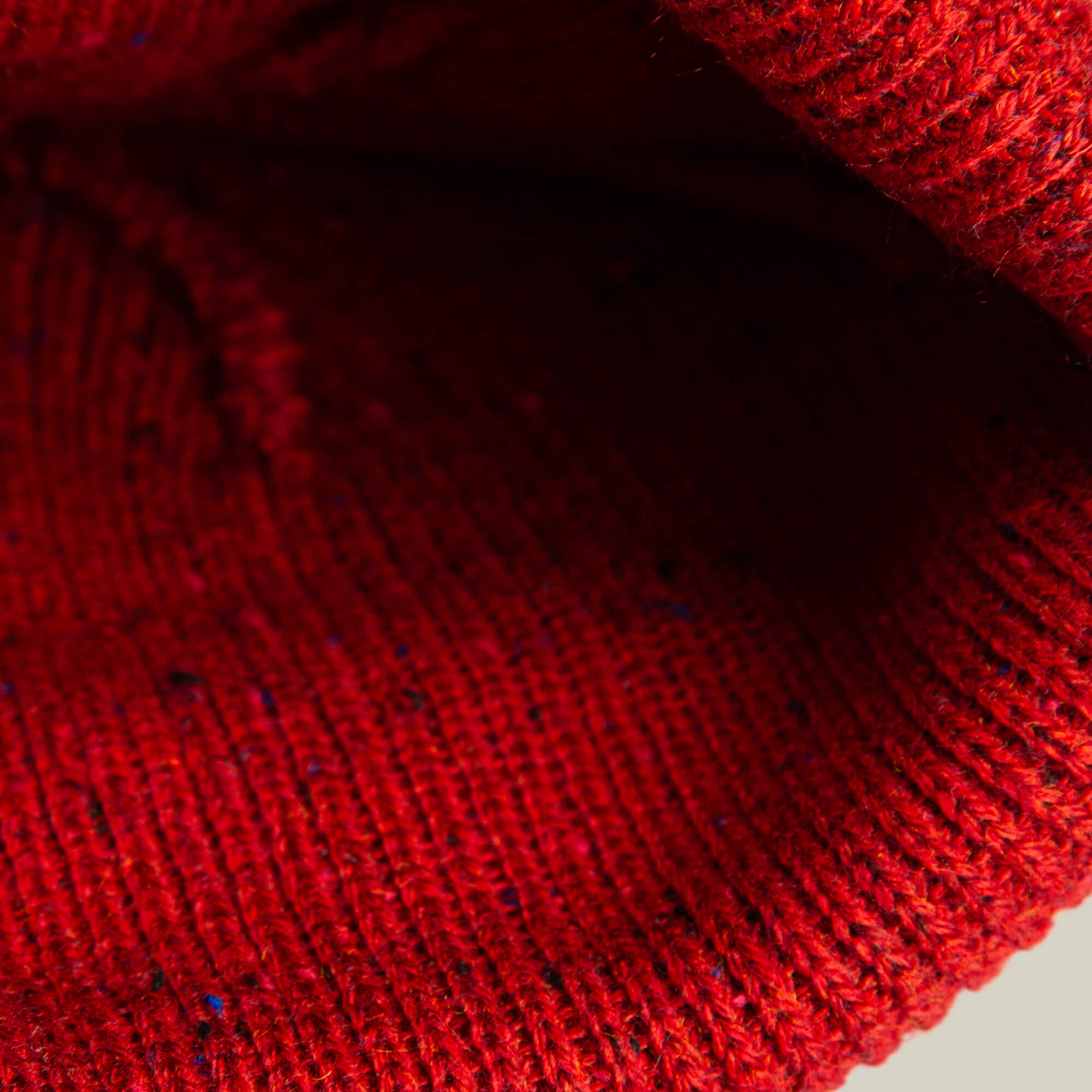 Close-up of the No Comply knit fabric by Goorin Bros., highlighting its red color and detailed stitching—perfect for cozy beanies or sweaters.
