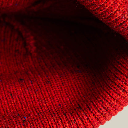 Close-up of the No Comply knit fabric by Goorin Bros., highlighting its red color and detailed stitching—perfect for cozy beanies or sweaters.