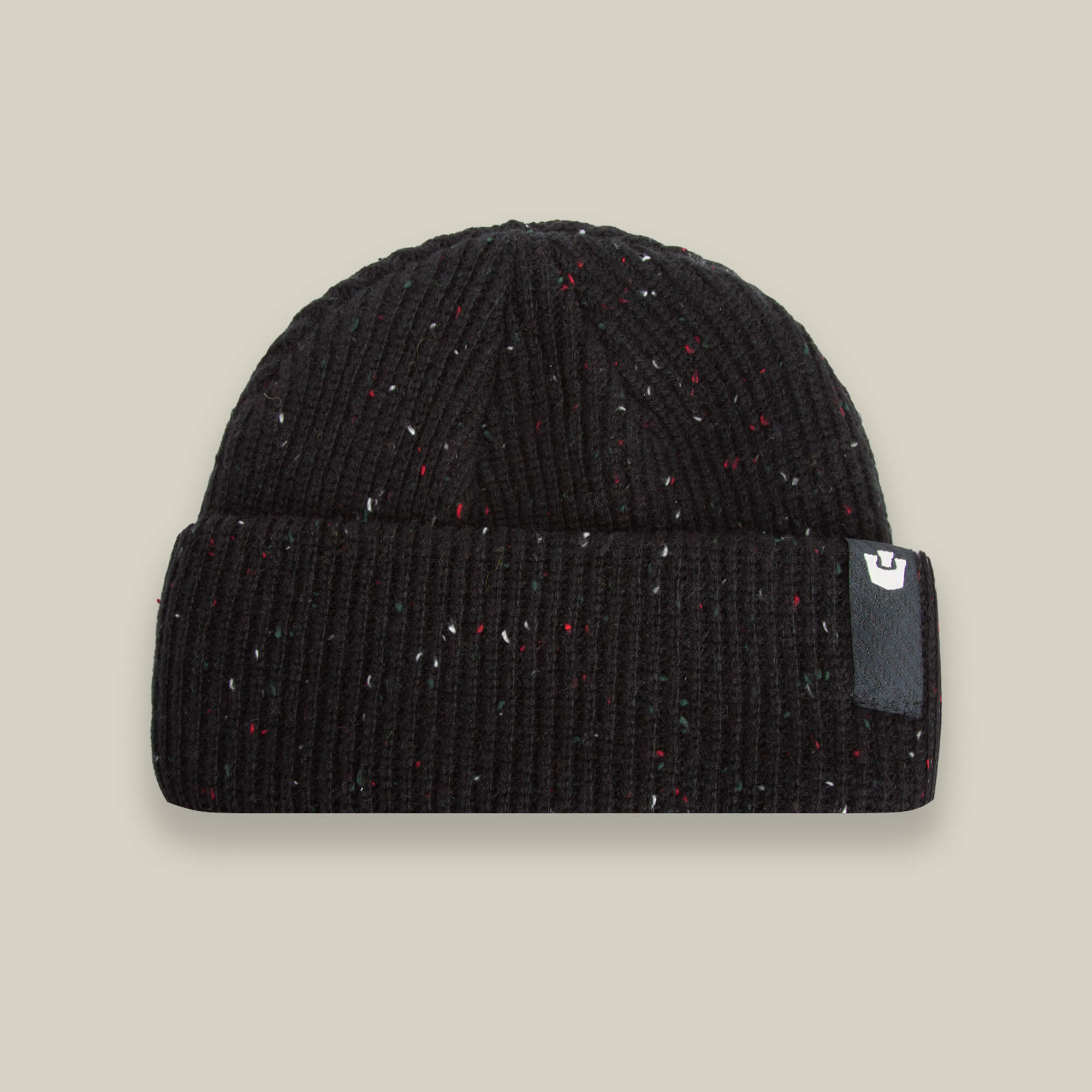 The Goorin Bros. No Comply beanie in black ribbed knit features subtle multicolored specks and a folded cuff with a small rectangular logo patch on the right side.