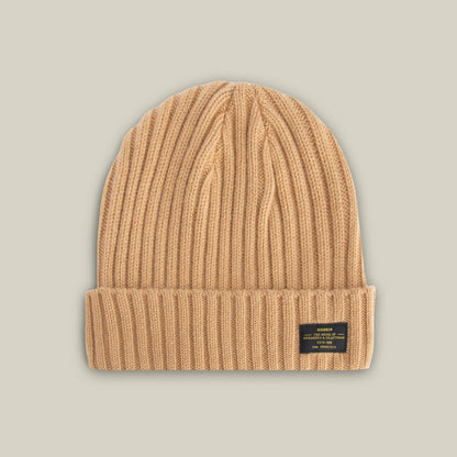 The Goorin Bros. Dream Cap is a luxurious beige ribbed knit beanie featuring a fold-over cuff and a small black rectangular label on the front right side, shown against a neutral background.