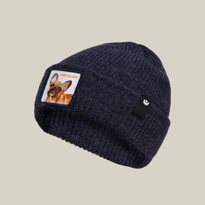 The High Class Beanie by Goorin Bros. is a navy knit winter hat featuring a dog patch and "HIGH CLASS" on the front, displayed against a plain beige background.