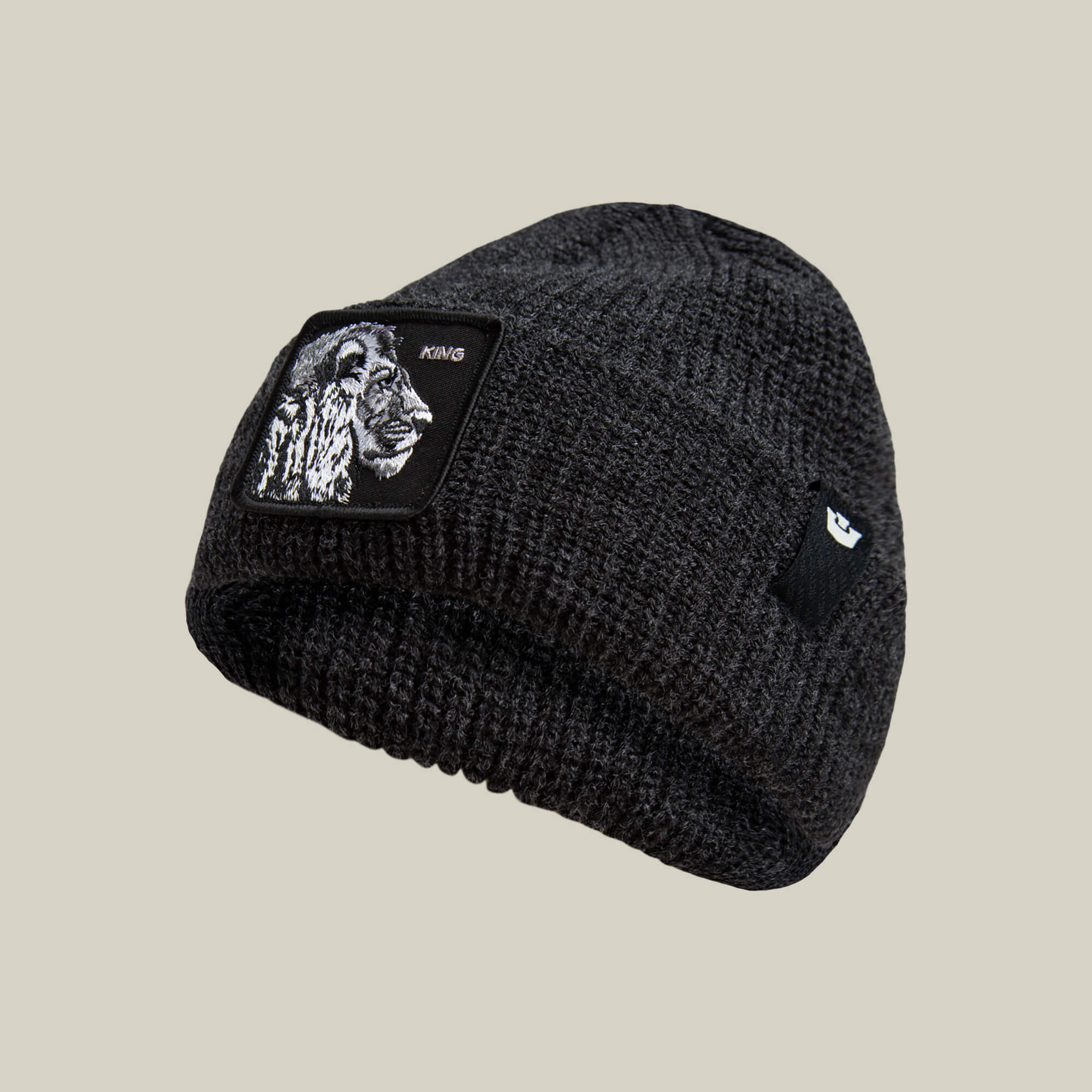 The Lion Beanie by Goorin Bros. is a black cuffed beanie with a lion patch and KING on the front, crafted in heavyweight knit for warmth and style.