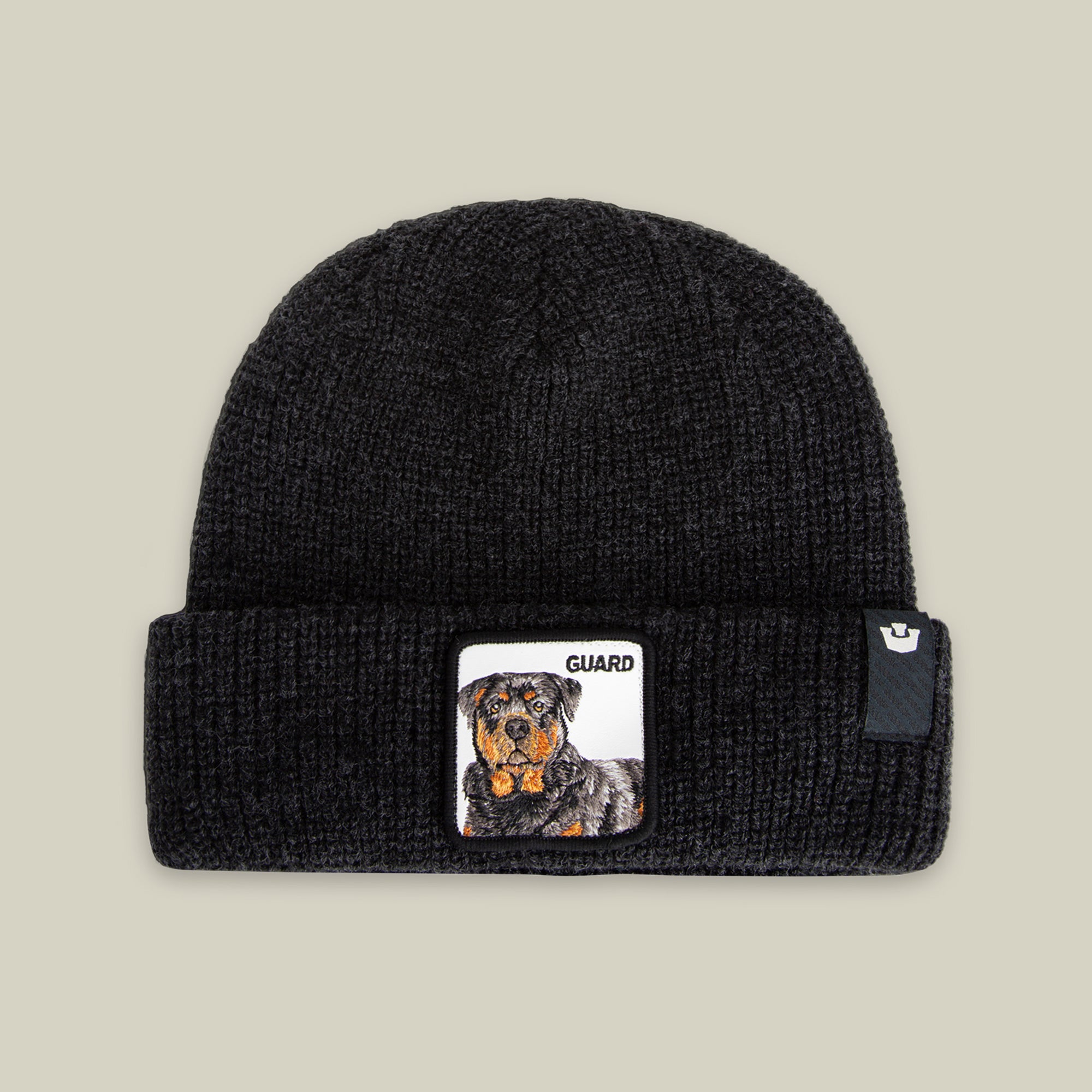 The Guard Beanie by Goorin Bros. is a black knit beanie with a bold Rottweiler patch and "GUARD" on the cuff—your perfect winter accessory.