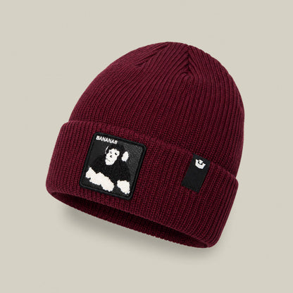 The Double Stuffed - Bananas Beanie by Goorin Bros. is crafted in a rich burgundy rib knit and features a warm, cuffed design with a folded brim, a black-and-white monkey patch, and a small black tag with the white Goorin Bros. logo.