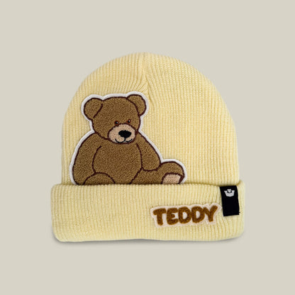 Introducing the Double Stuffed - Teddy Beanie - big by Goorin Bros., a cozy oversized knit beanie in Wax—a light yellow hue. Featuring an embroidered teddy bear and the word “TEDDY” on the folded brim, plus a small black tag on the side, this beanie offers soft warmth that’s perfect for chilly days.