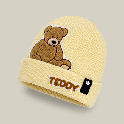 The Goorin Bros. Double Stuffed - Teddy Beanie - big is an oversized, yellow cozy knit beanie featuring an embroidered teddy bear and the word “TEDDY” on the cuff, plus a small black tag on the side, designed to offer soft warmth for chilly days.