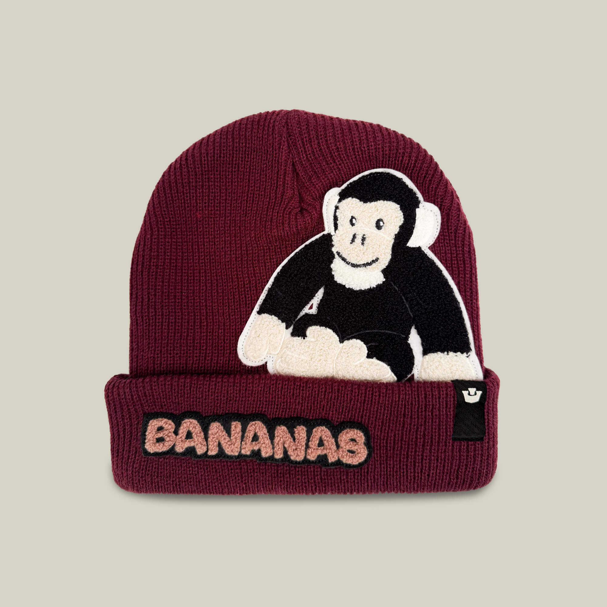 Keep warm in the Goorin Bros. Double Stuffed - Bananas Beanie - big, made from double-stuffed knit for added insulation. This beanie comes in a striking Desire Red color and features a bold chimpanzee patch, along with “BANANAS” embroidered on the folded brim—making it a playful and stylish accessory for chilly days.
